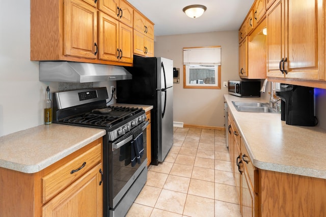 kitchen with stainless steel appliances, light tile patterned flooring, wall chimney range hood, and sink