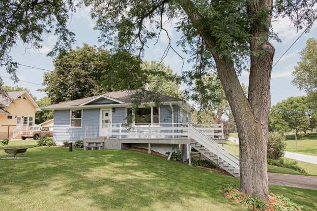 view of front of property with a front yard and a wooden deck