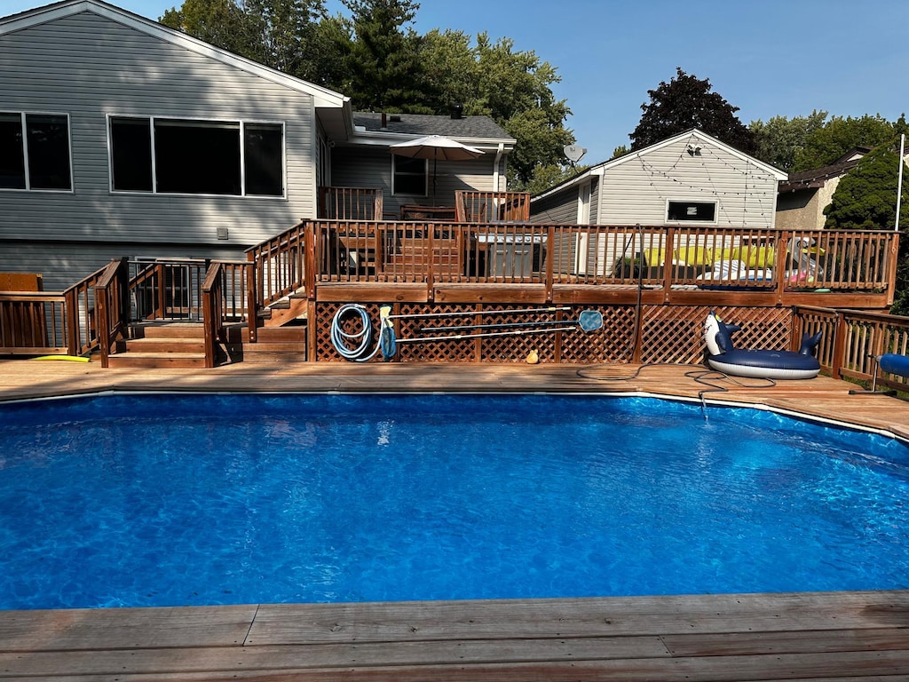 view of swimming pool with a wooden deck