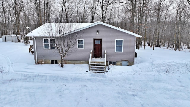 view of front of home with a storage shed