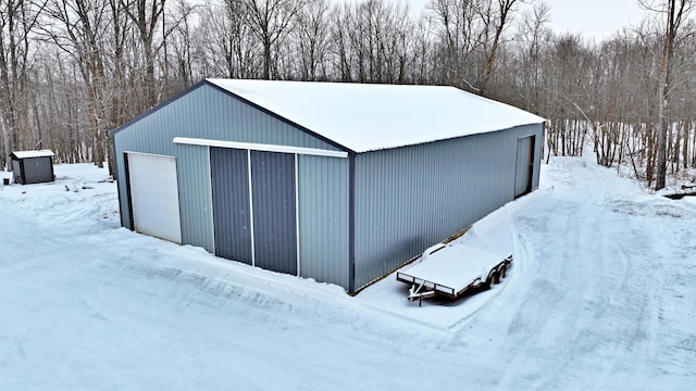 snow covered structure featuring an outdoor structure