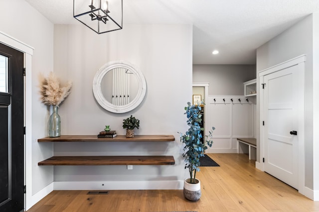 entrance foyer with a chandelier and light hardwood / wood-style flooring