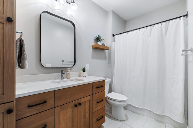 bathroom with toilet, tile patterned floors, and vanity