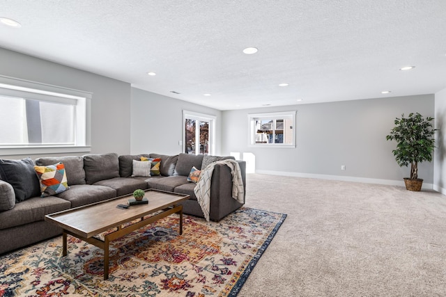 carpeted living room featuring a textured ceiling