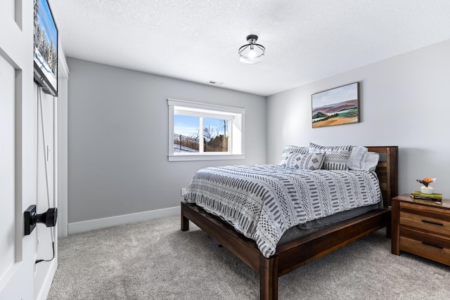 bedroom with a textured ceiling and carpet