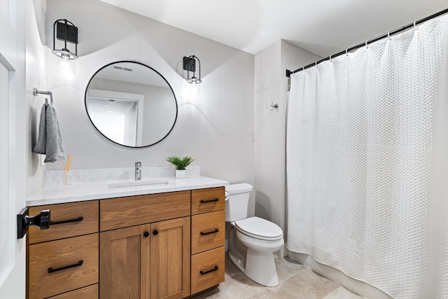 bathroom with vanity, toilet, and tile patterned flooring