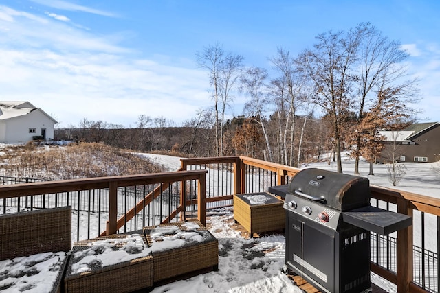 snow covered deck featuring grilling area