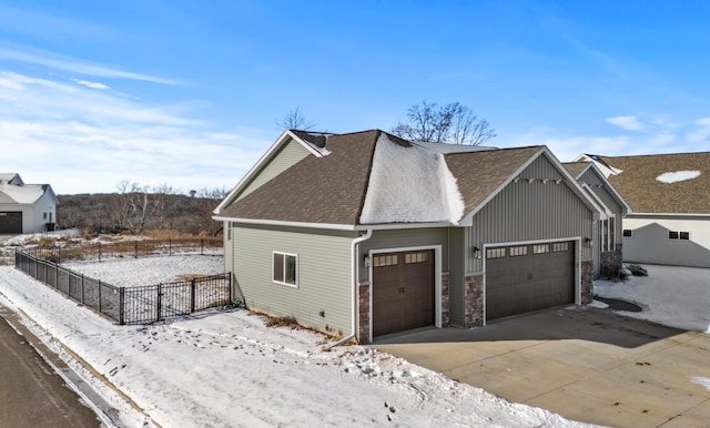 view of snowy exterior with a garage