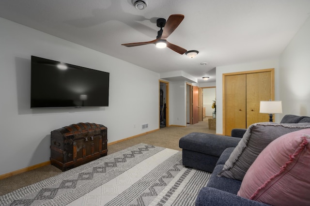 carpeted living room with ceiling fan