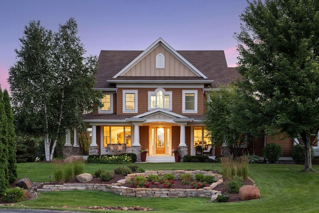 craftsman-style home with a lawn and a porch