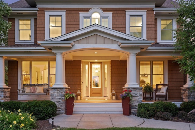 doorway to property featuring covered porch