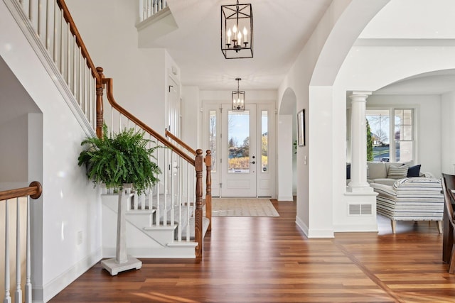 entryway featuring a chandelier and wood-type flooring