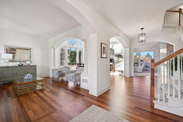 entryway with an inviting chandelier and dark hardwood / wood-style flooring