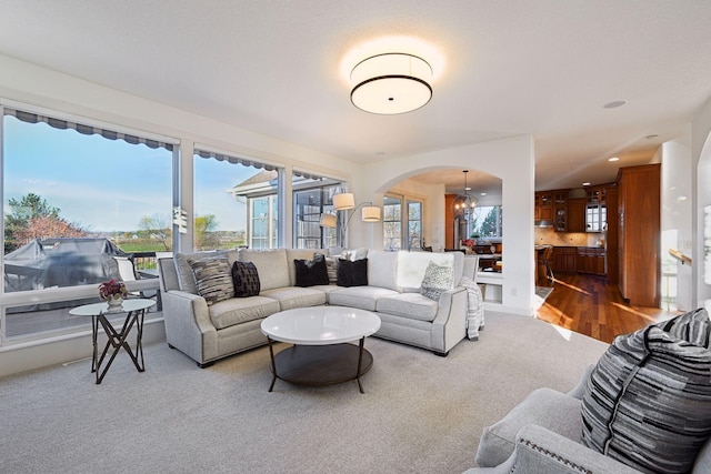 living room with an inviting chandelier and carpet flooring