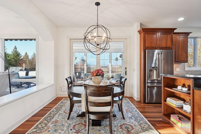 dining area featuring dark hardwood / wood-style flooring and a chandelier