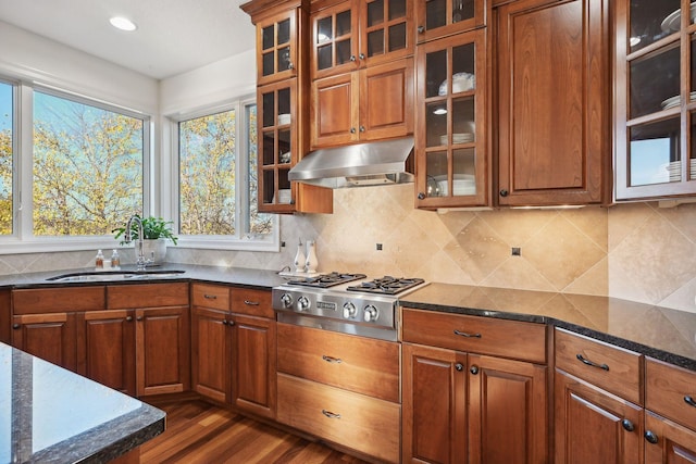 kitchen with dark stone countertops, sink, stainless steel gas cooktop, ventilation hood, and dark hardwood / wood-style flooring