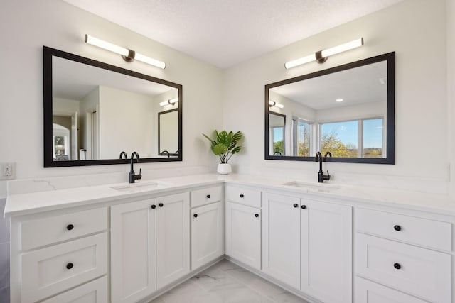 bathroom with a textured ceiling and vanity