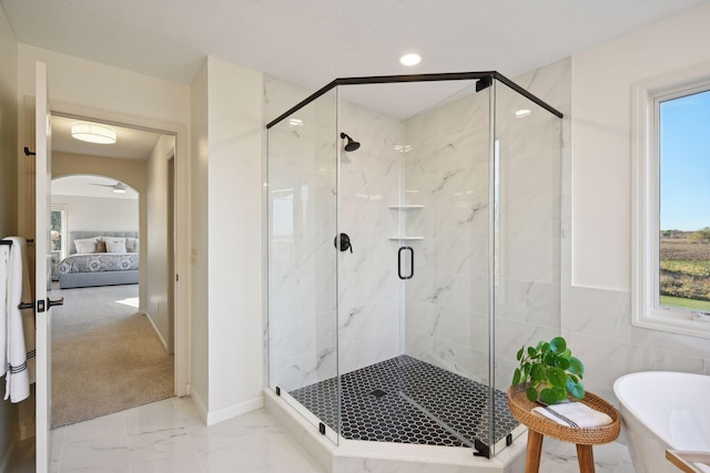 bathroom with tile walls and independent shower and bath