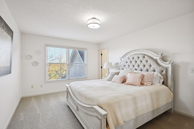 bedroom featuring a textured ceiling and carpet flooring