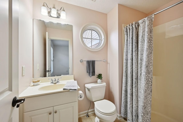 bathroom with a textured ceiling, toilet, and vanity