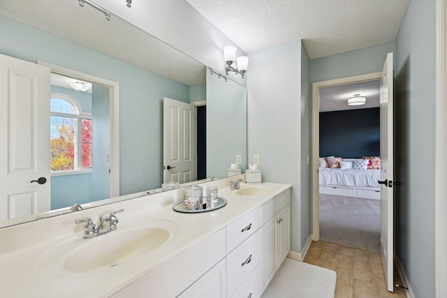 bathroom featuring a textured ceiling and vanity