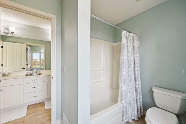 full bathroom featuring toilet, tile patterned floors, vanity, and shower / bath combo with shower curtain