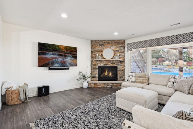 living room with wood-type flooring and a fireplace