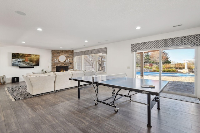 game room featuring hardwood / wood-style flooring and a fireplace