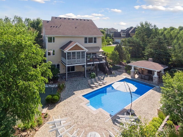 view of swimming pool featuring a bar and a patio