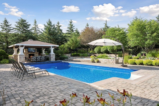 view of swimming pool featuring a patio, a gazebo, and exterior bar