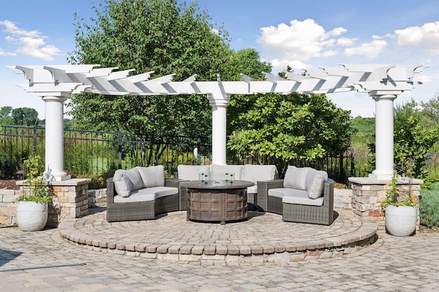 view of patio with an outdoor living space with a fire pit and a pergola