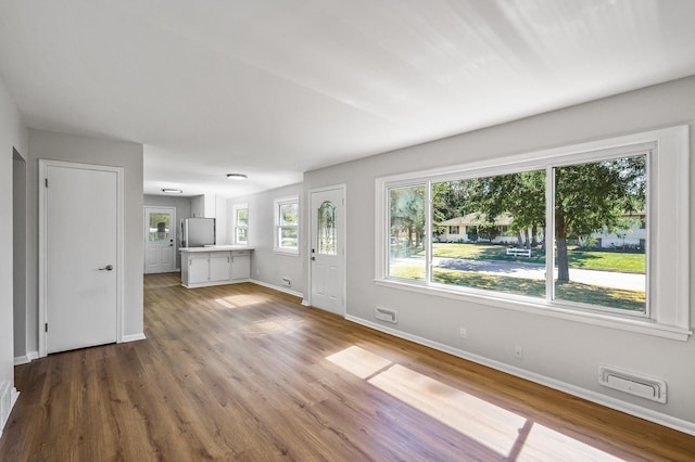 unfurnished living room with wood-type flooring