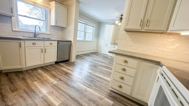 kitchen featuring ornamental molding, electric stove, a sink, stainless steel dishwasher, and light wood finished floors