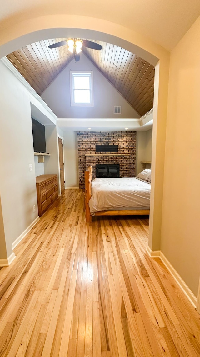 unfurnished bedroom featuring visible vents, baseboards, light wood-type flooring, lofted ceiling, and wooden ceiling