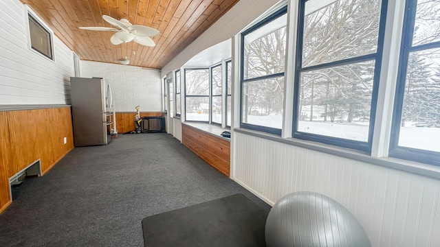 sunroom featuring wooden ceiling and ceiling fan