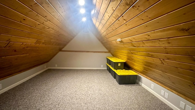 additional living space featuring baseboards, lofted ceiling, wood ceiling, and carpet flooring