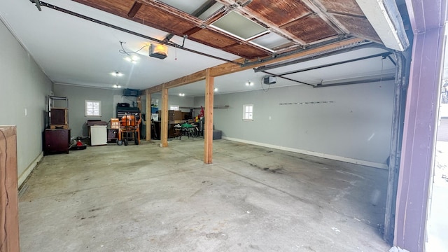 garage with a garage door opener and baseboards