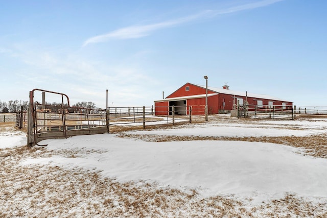 yard covered in snow with an outdoor structure and a rural view