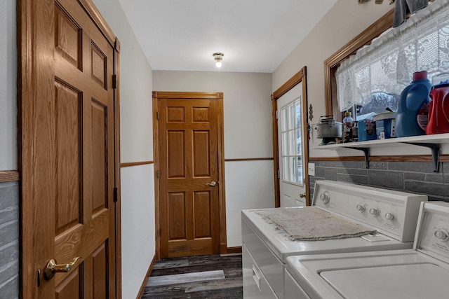 clothes washing area featuring washer and dryer and dark hardwood / wood-style flooring