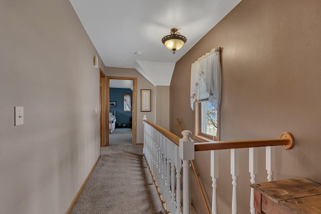 corridor featuring light colored carpet