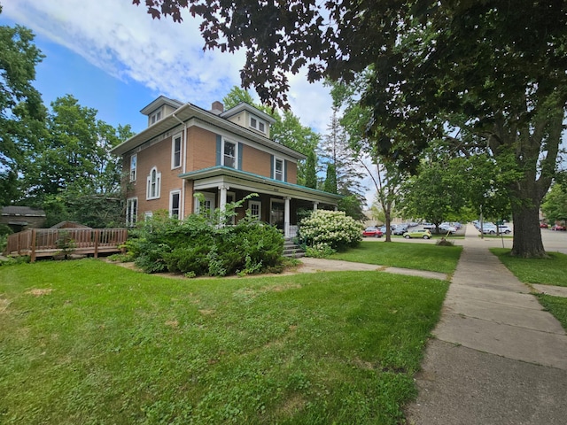 view of home's exterior with a lawn and a porch