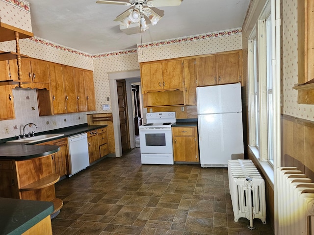 kitchen featuring ceiling fan, white appliances, radiator, and sink