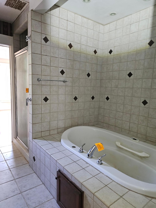 bathroom featuring tile patterned floors and shower with separate bathtub