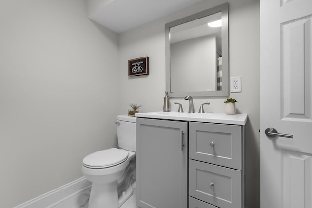 bathroom featuring toilet and vanity