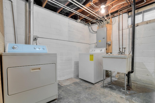 washroom featuring sink, electric panel, and independent washer and dryer