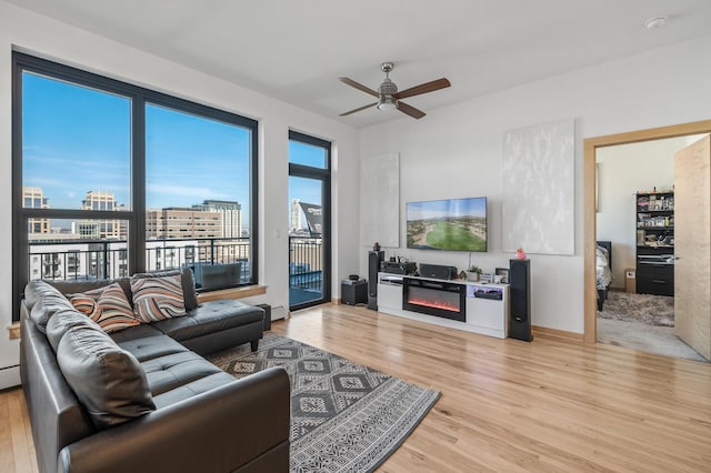 living room featuring ceiling fan and light wood-type flooring