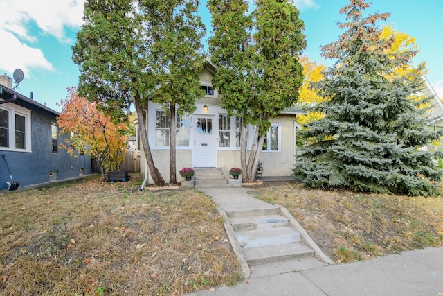 obstructed view of property featuring a front lawn