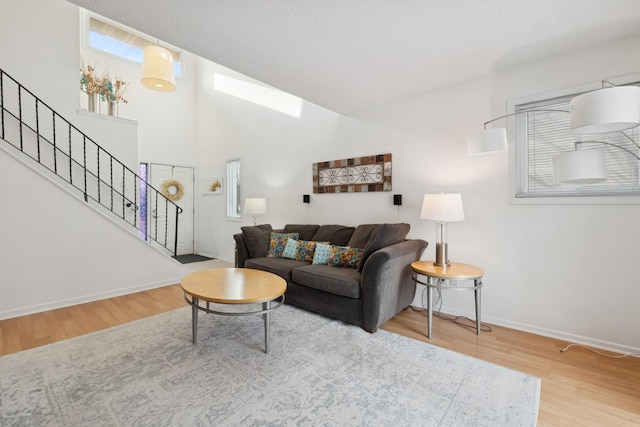 living room with hardwood / wood-style floors and a textured ceiling