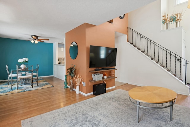 living room with hardwood / wood-style floors and ceiling fan