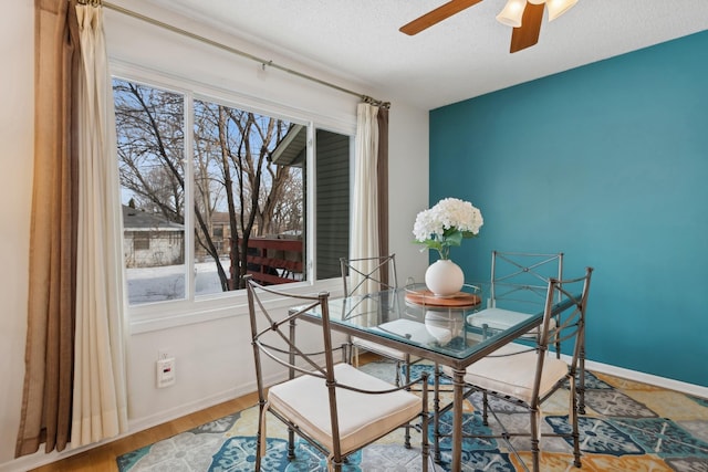 dining space with wood-type flooring, a textured ceiling, and ceiling fan